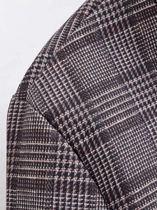 Close-up of vintage plaid blazer fabric showing premium wool blend and fine stitching