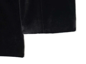 Close-up detail of luxurious black velvet fabric with a soft glossy texture for rompers