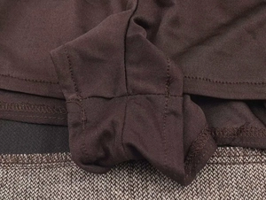 Detailed close-up showing precision stitching on dark brown wool blend knitted fabric