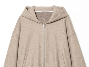 Detail of oatmeal hooded jacket with smooth metal zipper and soft textured fabric