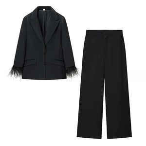 Chic women's black suit set with feather-trimmed cuffs and high-waist wide-leg pants