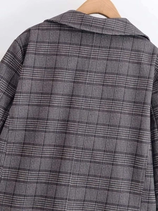 Close-up of the back neckline and seam detail on a grey plaid blazer jacket