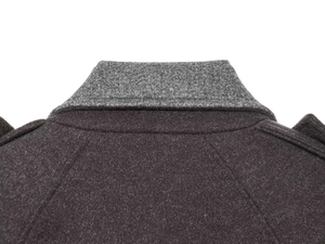 Detailed macro view of the color-block wool coat collar and shoulder stitching