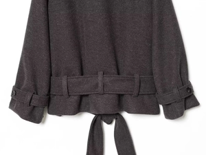 Detailed close-up of dark grey wool coat hem, adjustable cuffs, and matching waist tie belt