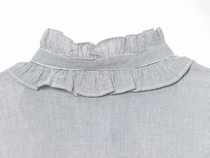 Detail of ruffled high neck design and fine stripes on a cotton blend blouse