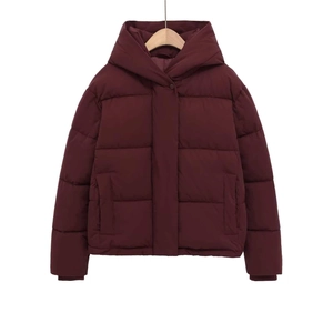 Detail of burgundy hooded puffer jacket with wide quilting and hidden placket design