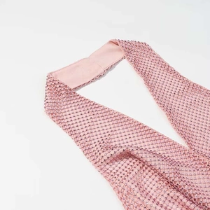 Detail of pink mesh halter top featuring sparkling rhinestones and delicate mesh fabric