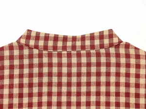 Detail of red gingham check pattern and stitching on the stand collar of the shirt