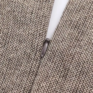 Detailed macro view of the invisible zipper on a slim-fit tweed wool blend dress