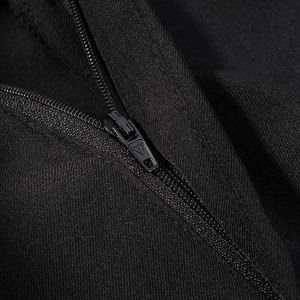 Close-up detail of smooth black metal zipper head on elegant twill fabric jacket