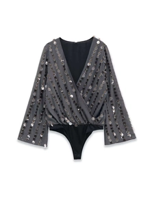 Detail showing vertical silver sequins on the deep V-neck wrap bodysuit fabric