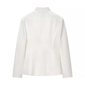Detail view of the back of a slim fit white blazer showing tailored seams and waist design
