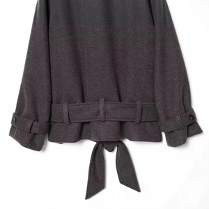 Dark charcoal wool blend coat featuring adjustable sleeve buckles and waist belt details