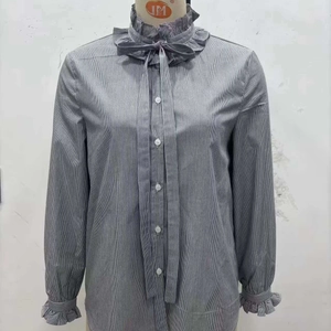 Striped long sleeve shirt featuring ruffle collar and drawstring bow on mannequin