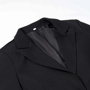 Close-up of classic black blazer notched lapel with high-quality interior stitching detail