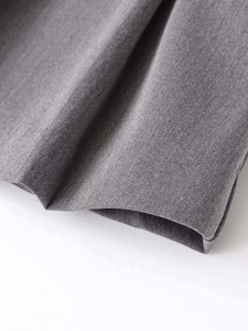Close-up of grey twill denim fabric detailing showing high-quality stitching and texture