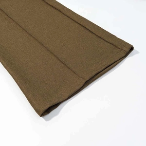 Detailed close-up showing the twill fabric texture and stitched hem of brown suit trousers