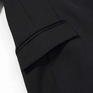 Macro detail of high-quality black blazer pocket with neat stitching and twill fabric