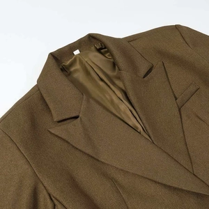 Detailed close-up of dark olive twill blazer featuring notched lapel and silk-like lining