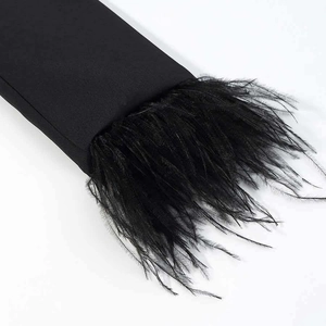 Detail of elegant black blazer sleeve featuring premium faux ostrich feather trim finish