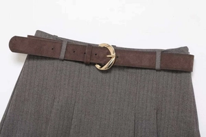 Detail view of herringbone fabric skirt featuring a dark brown suede belt and gold buckle
