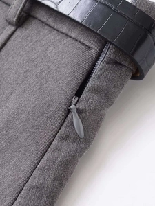 Detail of dark gray twill fabric skirt with black embossed belt and invisible side zipper