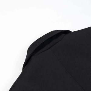 Detail of black blazer shoulder showing high-quality twill weave fabric and neat stitching