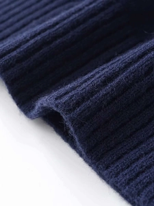 Macro shot of navy blue ribbed knit fabric showing detailed texture and soft fibers