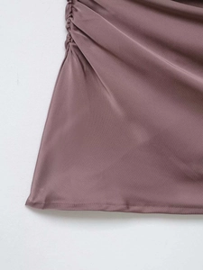 Close-up of side ruching detail on smoky purple satin fabric with silky texture