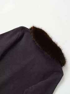 Detailed view of brown knit cardigan featuring a plush faux fur collar and ribbed texture