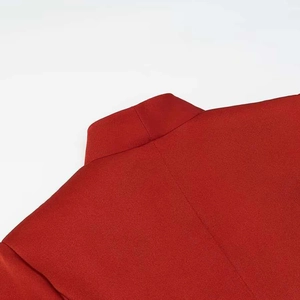 Detail of red stand-up collar blazer showing high-quality fine texture and stitching