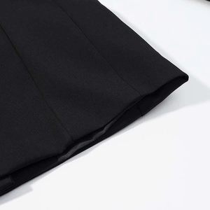 Close-up of black twill fabric on women's trousers with neat stitching and smooth texture