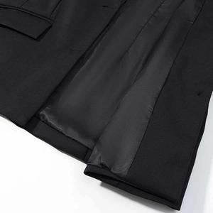 Detailed close-up of blazer inner lining showing black satin fabric and sewing quality