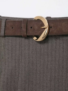 Detailed close-up of grey herringbone skort with brown matte leather belt and gold buckle