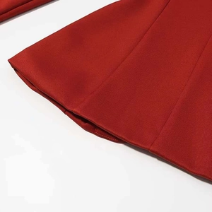 Macro detail of the high-quality stitching and red twill fabric on fashion trousers