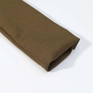 Detailed macro view of olive green twill fabric texture on the blazer jacket sleeve