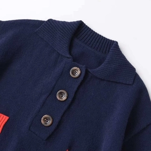 Short sleeve knit polo top in navy blue with contrast red trim and wood-grain buttons