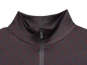 Detail of zip-up stand collar jacket featuring dark red and navy geometric diamond pattern