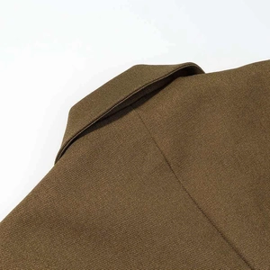 Close-up of khaki blazer featuring professional lapel design and twill texture fabric