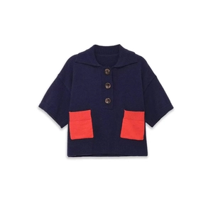 Kids navy blue knit polo shirt with orange contrast pockets and brown buttons