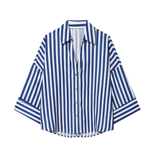 Close-up of blue striped shirt showing brown buttons and size L collar tag detail