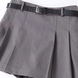 Grey pleated mini skirt with high waist design and black embossed leather belt