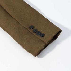 Detail of suit sleeve cuffs with four dark buttons on olive twill fabric texture
