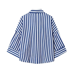 Close-up of blue and white vertical striped shirt featuring contrast cuff detail and collar