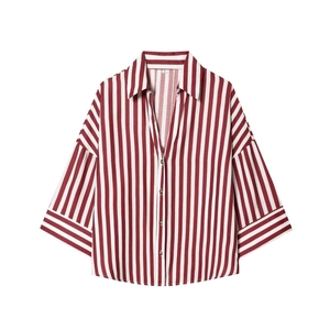 Detailed flat lay of red and white striped V-neck shirt with wide sleeves and buttons