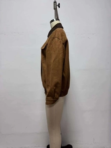 Detailed side view of a brown faux suede jacket with contrasting dark brown collar
