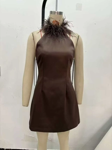 Detail of a brown halter neck mini dress featuring premium faux leather and feather collar