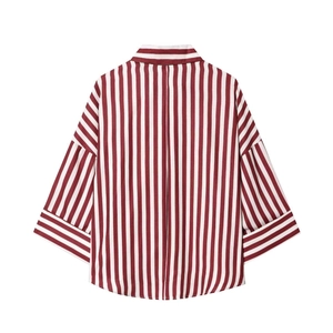 Detail view of the back of a vintage red and white vertical striped V-neck shirt