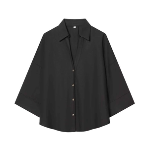 Detail view of black loose short sleeve shirt with v-neck collar and small front buttons