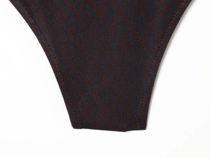 Detailed view of the dark red and blue geometric diamond pattern on a slim jumpsuit